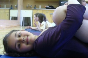 A Child Enjoys Her Happy Brain during a Young Yoga Masters Kids Yoga Class A Child Enjoys Her Happy Brain during a Young Yoga Masters Kids Yoga Class