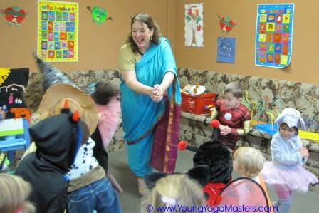 halloween2009-Kids-Yoga-Training a yoga teacher is teaching kids on Halloween and all the children are wearing costumes